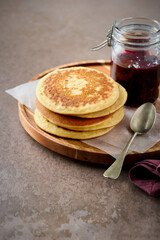 Pancakes, stack, rustic, breakfast, food, sweet, homemade, cozy, wooden, golden, bakery, artisan, healthy, delicious. Homemade pancakes on a wooden board for breakfast.