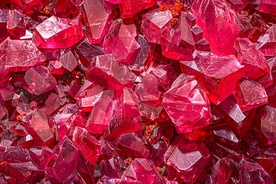 Macro shot of rough pink crystals, showcasing their vivid color, sharp edges, and glistening surface.