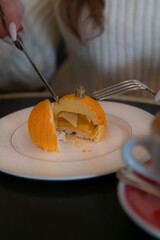 Delicate dessert served on a plate with a fork and knife at a cafe in an elegant setting in the afternoon