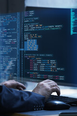 Hands working on keyboard with fictional code display, representing virtual interplay of human...