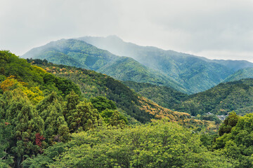 Beautiful scenic natural landscape with the tree covered mountains in Arashiyama district of Kyoto.