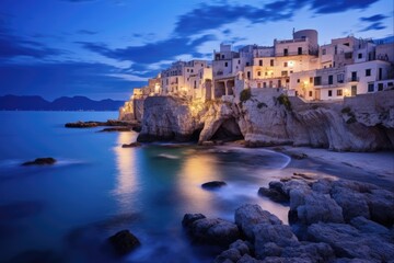 Twilight on the Adriatic: Exploring Puglia's Coastal Town of Vieste, Italy. Highlighting the city's bay, beach, and cathedral on its rocky cape
