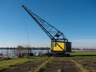 Old Crane at an Abandoned Brick Factory by the River, Drone Shot