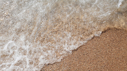 Much sand and meershaum in the sea, river, lake, ocean water. Nature background.