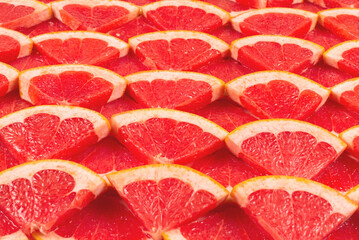 Grapefruit red juicy slices background. top view.