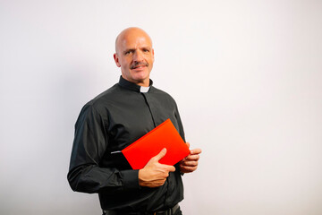Portrait of a priest holding a bible.