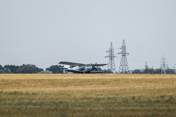 Fototapeta premium An-2 single-engine biplane passenger aircraft on airshow field