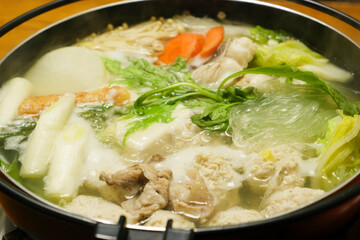 Hot pot with fish meat, vegetables, chicken meatballs and mushrooms as ingredients, a classic Japanese winter dish