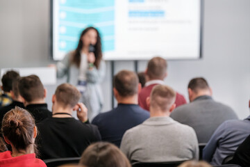 Obraz premium Group listens to speaker presentation in conference room, focusing on learning, education, and discussion.