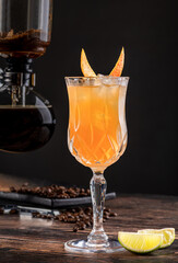 Alcoholic luxury cocktail with coffee and orange on dark background
