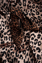 Leopard print high heel shoes on leopard print. Flat lay, top view, overhead. fashion animal print