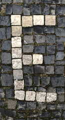 The letter E written in cobblestones