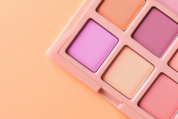 Fototapeta premium Vibrant eyeshadow palettes arranged artfully on a soft peach backdrop for an inviting beauty display