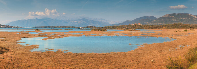 Breathtaking panoramic view of Tivat Solila nature reserve with its serene wetlands, framed by the imposing mountains