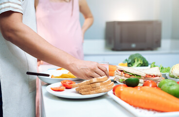A close-up of healthy food on a kitchen table, featuring fresh vegetables, fruits, and organic ingredients, highlighting wellness, healthy eating, and meal preparation in a modern home kitchen