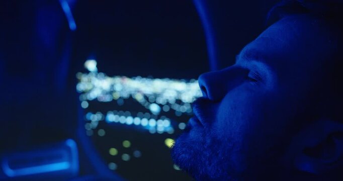 a man sleeping in an airplane in the background an airplane window