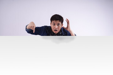 image of Asian man standing and posing with billboard