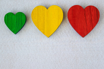 Obraz premium Traffic light green, yellow, red hearts on the red background.