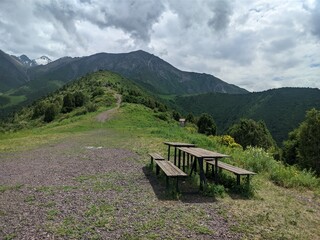 Naklejka premium Picnic tables at scenic mountain viewpoint in Tian Shan, Kyrgyzstan