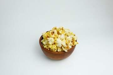 Fresh popcorn in a white wooden bowl