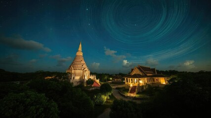 Breathtaking view of Wat Pa Phu Kon temple with swirling clouds under the starry night sky, stars, Wat Pa Phu Kon
