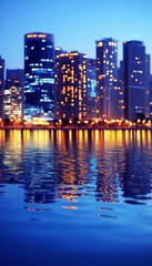 Obraz premium Dynamic City Skyline At Dusk With Reflections,. Vivid Colors, Soft Focus, Modern Architecture.