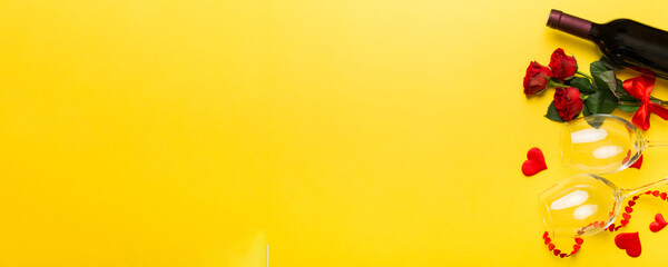 Valentine's day composition with red wine, rose flower and gift box on table. Top view, flat lay. Holiday concept