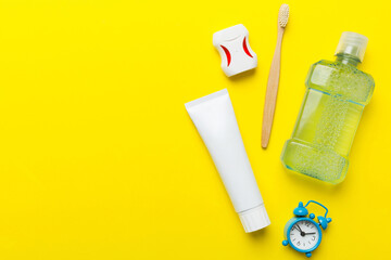 Mouthwash and other oral hygiene products on colored table top view with copy space. Flat lay. Dental hygiene. Oral care products and space for text on light background. concept