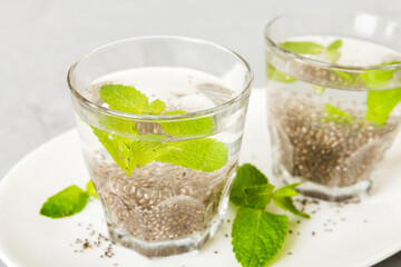 Healthy breakfast or morning with chia seeds and mint on table background, vegetarian food, diet and health concept. Chia pudding with and mint