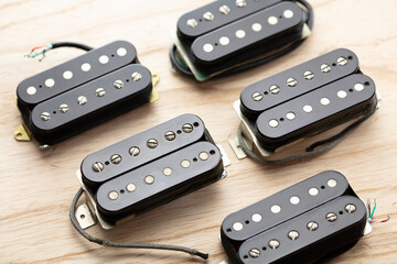 Humbuckers. Electric guitar humbucker type magnetic pickup (double coil ) on ash lumber wood...