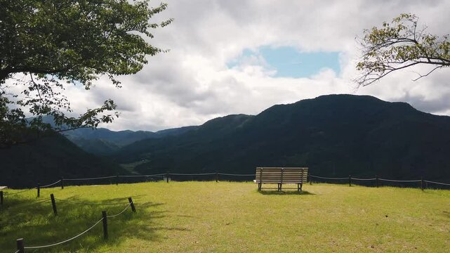 Relaxing bench landscape alone looking at Mountains of Japanese Valley in summer