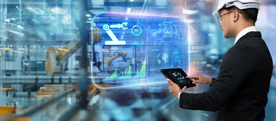 Smart technology industry control concept.Hands holding tablet on blurred automation machine as background