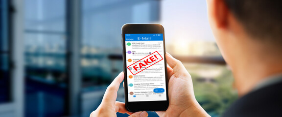 Fake E-mail scam or phishing concept. Man hands using smart phone
