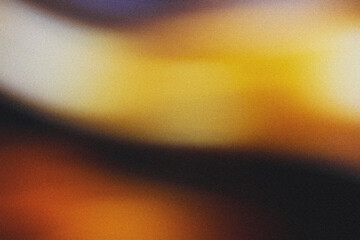 A blurred blend of golden and brown hues with grainy texture and noise, creating a soft backdrop.