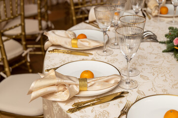 Beautiful table decoration for luxury  event in pink and gold, cutlery and tableware, banquet hall arrangement decor, celebration in restaurant with flowers, candles on a wedding reception party