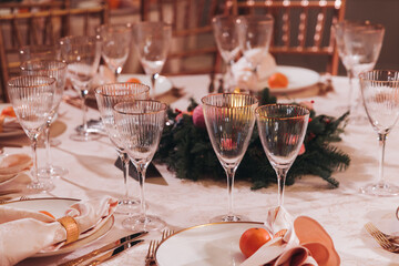 Beautiful table decoration for luxury  event in pink and gold, cutlery and tableware, banquet hall arrangement decor, celebration in restaurant with flowers, candles on a wedding reception party