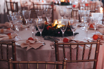 Beautiful table decoration for luxury  event in pink and gold, cutlery and tableware, banquet hall arrangement decor, celebration in restaurant with flowers, candles on a wedding reception party