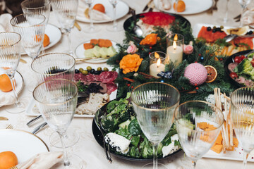 Beautiful table decoration for luxury  event in pink and gold, cutlery and tableware, banquet hall arrangement decor, celebration in restaurant with flowers, candles on a wedding reception party