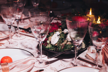 Beautiful table decoration for luxury  event in pink and gold, cutlery and tableware, banquet hall arrangement decor, celebration in restaurant with flowers, candles on a wedding reception party