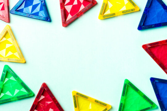 Magnet tiles on a Bright Blue Background. Geometric Triangles.