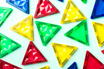 Magnet tiles on a Bright Blue Background. Geometric Triangles.