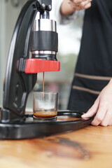 the process of making coffee manually by brewing, pouring water until the coffee pressing process on the table with coffee equipment nearby
