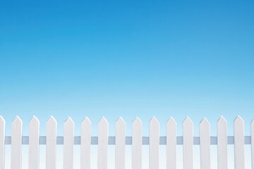 Fototapeta premium Snow-dusted fence under a clear blue sky showcases the serenity of winter landscapes in a peaceful outdoor setting