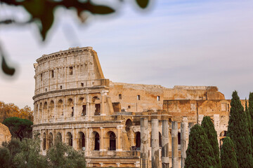 Obraz premium Panoramic view of old Colosseum in Rome. Beautiful popular of ancient landmark. Famous card of city of Rome, Italy. High quality photo