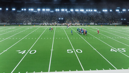 Aerial Shot of American Football Players Facing Each Other On the Field. Game Starts and an Athlete...