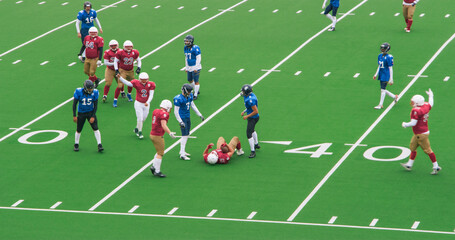 Red and Blue American Football Teams Battle for the Championship Trophy. Powerful Footballers  Scoring Points. Gridiron Tournament