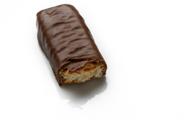 Indulgent chocolate treat lying temptingly on a reflective surface with a bite taken out