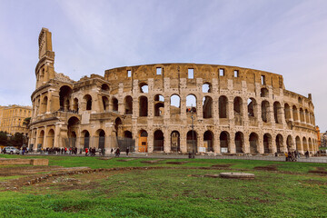 Naklejka premium Panoramic view of old Colosseum in Rome. Beautiful popular of ancient landmark. Famous card of city of Rome, Italy. High quality photo