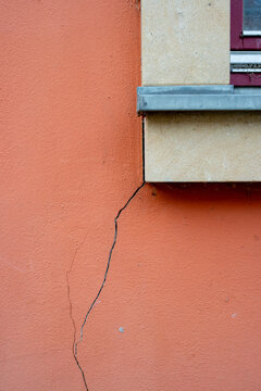 Crack in a wall on the window construction defects vertical