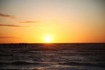 Golden Sunset Over the Baltic Sea: People Watching from the Palanga Pier, Lithuania